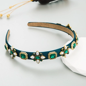 Baroque retro emerald crystal headband with pearls and green velvet fabric on display stand