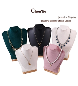 Detail of five multi-colored velvet necklace display busts with premium solid wood bases