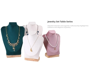 Detail of velvet and leather necklace bust displays with solid wood bases in various colors