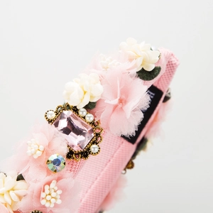 Handmade pink fabric headband with rhinestone flowers and beads in a soft floral design