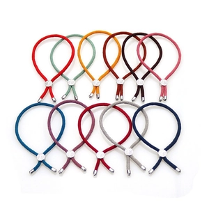 Detailed view of ten colorful adjustable braided nylon cord bracelets with metallic leaf sliders