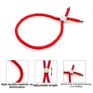 Detail of red braided cord bracelet with adjustable silver hollow leaf metal bead