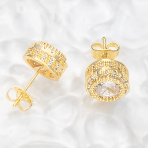 Detailed macro view of gold-plated round halo earrings with center white zircon and butterfly back