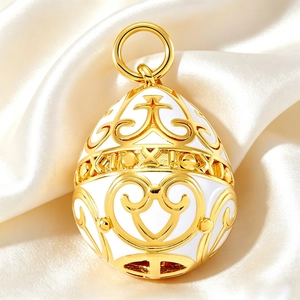 Detailed view of Fabergé style white enamel egg pendant with gold hollow floral patterns
