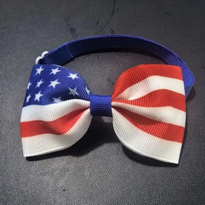 Detail of USA flag pet bowtie with blue stars and red white stripes on grosgrain ribbon