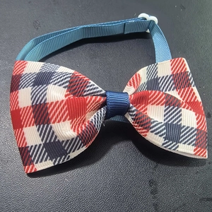 Detail of Independence Day pet bowtie with red white and blue plaid fabric and adjustable buckle