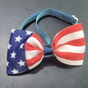 Detail of Independence Day pet bowtie with patriotic stars and stripes pattern and clip