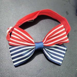 Detail view of Independence Day striped pet bowtie with adjustable red neck strap