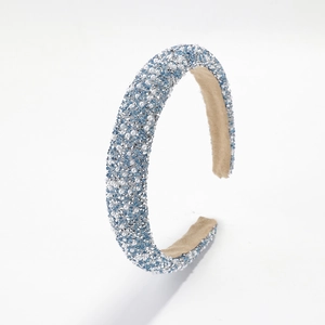 Chic blue padded headband with sparkling crystals and pearls on white background