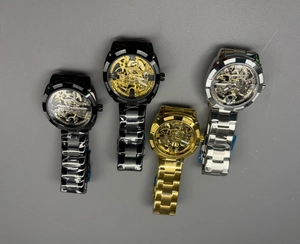 Collection of skeleton mechanical watches with metal straps in gold, silver, and black