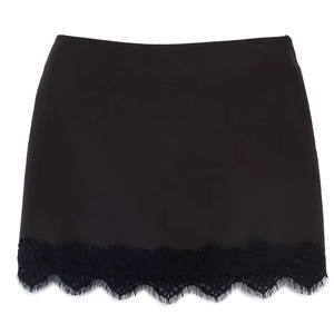 Detail of elegant black mini skirt featuring delicate eyelash lace trim on the hemline