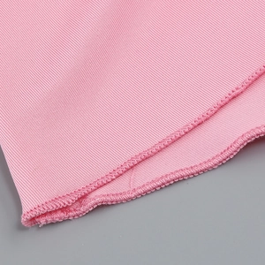 Close-up of pink knit fabric showing detailed stitching and fine texture of the dress