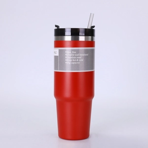 Close-up of red stainless steel insulated tumbler with a black lid and clear straw detail