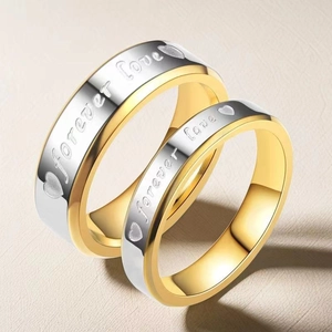 Detail of couple rings with Forever Love engraving and gold-silver dual tone finish