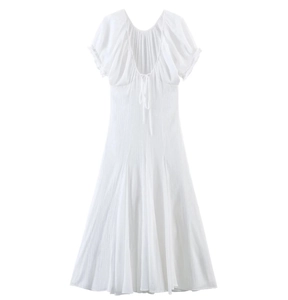 Close-up of white midi dress featuring pleated tulle fabric and elegant bow tie back detail