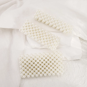Macro shot of multi-row pearl woven headbands featuring elegant white ABS bead textures