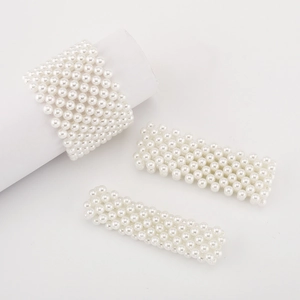 Macro view of wide multi-row pearl stretch bracelet with woven rectangular grid design