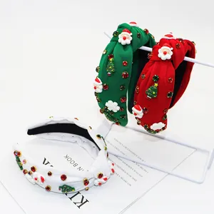 Detailed view of Christmas headbands with Santa, trees and rhinestones on velvet