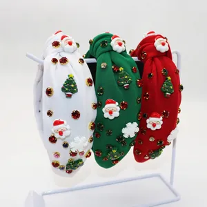 Three knotted Christmas headbands with Santa, trees, and rhinestones on white stands
