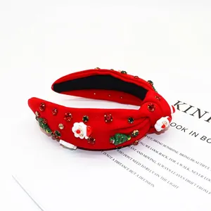 Red Christmas knotted headband with sparkling rhinestones and festive Santa decorations