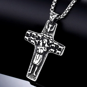 Vintage silver cross necklace with detailed religious reliefs on a black box chain
