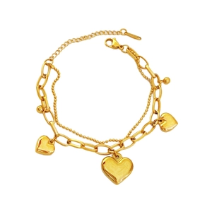 Gold plated stainless steel chunky chain bracelet with triple heart charms on white background