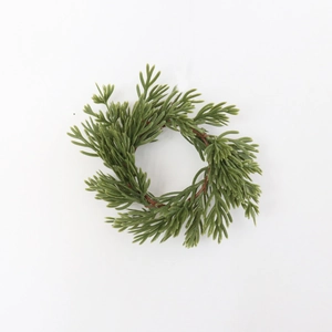 Realistic artificial pine needle napkin ring wreath with brown vine base on white background