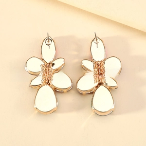 Detailed back view of vintage leaf earrings featuring golden metal base and pin closure