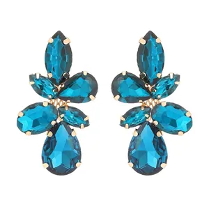 Elegant gold earrings with royal blue leaf-shaped crystals in a vintage cluster design