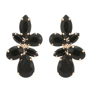 Detail view of black gemstone petal earrings with multifaceted pear-shaped stones and gold settings