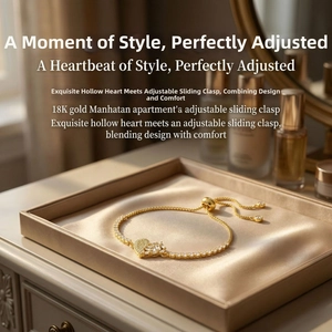 Close-up of 18K gold plated heart bracelet with sparkling zircons on champagne satin