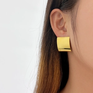 Detailed view of large square 18K gold-plated stainless steel earrings on model
