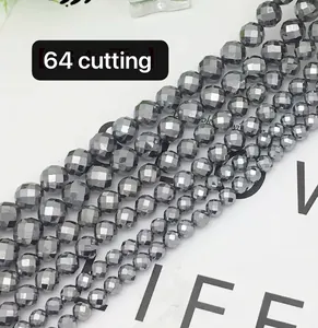 Macro detail of 64-cut faceted terahertz gemstone beads in metallic dark grey