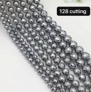 Macro detail of faceted Terahertz beads with 128-facet cut and dark grey metallic luster