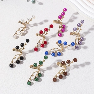 Detailed view of spiral pearl rings set in eight colors with golden alloy finish