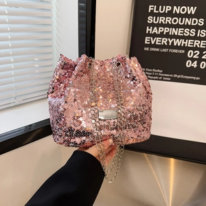 Close-up of pink sequin bucket bag featuring metallic chain and drawstring closure detail