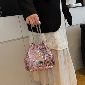 Detail of pink sequin bucket bag with silver metal plaque and elegant chain handle