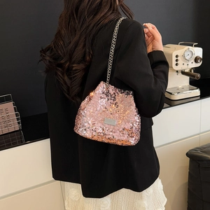 Detail of pink sequin texture and metallic brand plate on fashion chain shoulder bag