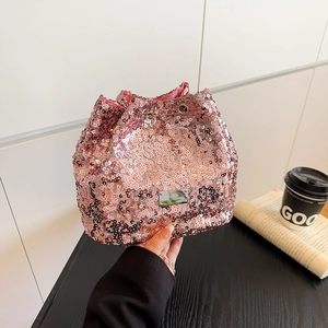 Detail of pink sequin bucket bag featuring metallic chain strap and satin lining
