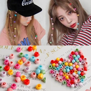 Detailed view of colorful mini candy-colored plastic claw hair clips for creative braiding