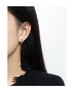 Close-up of minimalist S925 sterling silver C-shaped hoop earrings with beaded texture