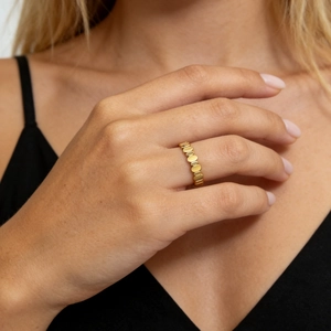 Close-up of a gold minimalist ring featuring a unique linked oval chain design on a finger