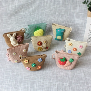 Flat lay of diverse straw crossbody coin purses with cute rabbit and flower motifs