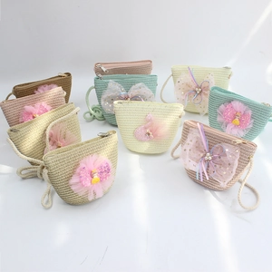 Detail of colorful shell-shaped straw bags with lace bows and sequins for girls