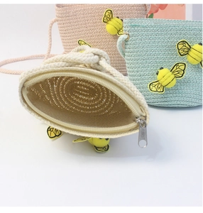 Close-up of colorful straw woven coin purses for kids with cute 3D bee decorations