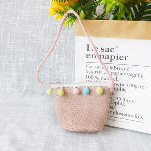 Cute oat pink straw woven coin purse for girls featuring colorful macaron pom-poms