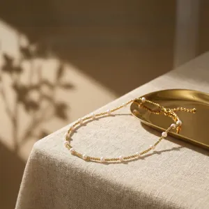 Detail of freshwater pearl and 18K gold-plated bead necklace with an elegant lobster clasp