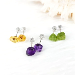 Detailed set of three natural raw gemstone stud earrings in purple, yellow, and green tones