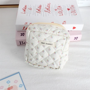Aesthetic quilted floral cosmetic bag with zipper closure and woven MAY RABBIT label