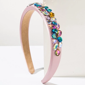 Detail of pink sponge headband with multi-colored crystals in a baroque luxury style